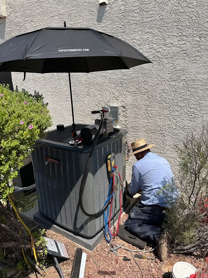 HVAC technician performing outdoor AC maintenance in Longview